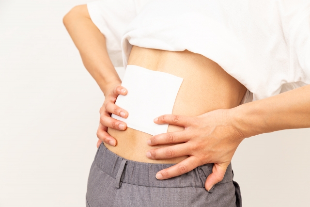 湿布を貼った女性の腰